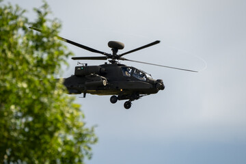 close-up side view of a British army Boeing Apache Attack helicopter gunship AH64E AH-64E ArmyAirCorp in low level flight