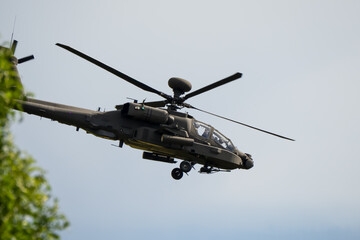 close-up side view of a British army Boeing Apache Attack helicopter gunship AH64E AH-64E ArmyAirCorp in low level flight