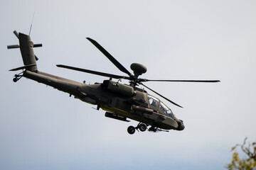 close-up side view of a British army Boeing Apache Attack helicopter gunship AH64E AH-64E ArmyAirCorp in low level flight