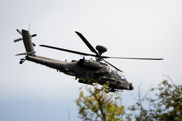 close-up side view of a British army Boeing Apache Attack helicopter gunship AH64E AH-64E ArmyAirCorp in low level flight