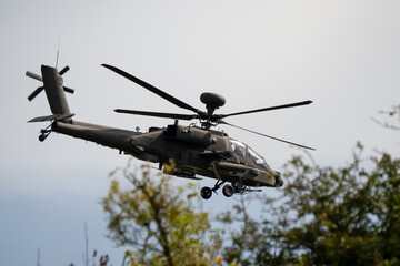 close-up side view of a British army Boeing Apache Attack helicopter gunship AH64E AH-64E ArmyAirCorp in low level flight