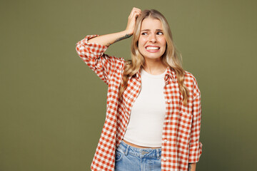 Young sad shocked mistaken upset confused woman she wear red shirt white t-shirt casual clothes put...