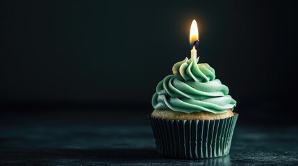 Aesthetic green cupcake featuring a candle against a dark background perfect for anniversary celebrations with ample copy space