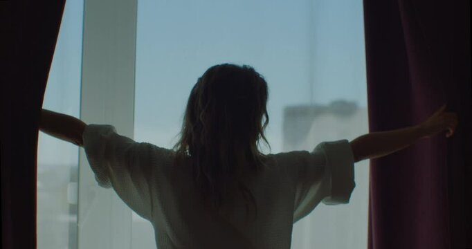 Happy woman wear dressing gown come to big window open lace curtain look outside, young beautiful lady enjoy view feel fresh motivated start new day in modern home, good morning lifestyle concept