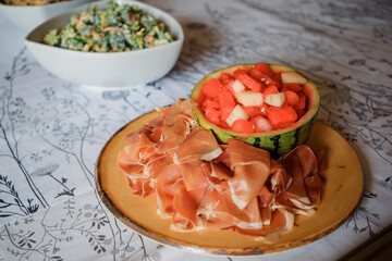 Watermelon salad with prosciutto crudo and melon