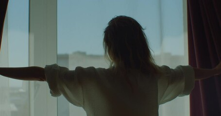 Happy woman wear dressing gown come to big window open lace curtain look outside, young beautiful lady enjoy view feel fresh motivated start new day in modern home, good morning lifestyle concept.
