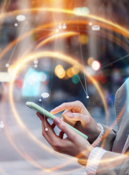 Young woman with smartphone in her hands. Outdoors. Global networking concept