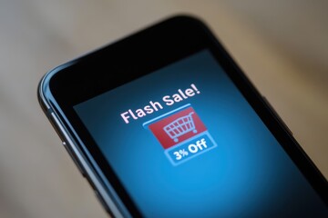 Flash Sale Notification: A close-up of a smartphone screen showing a notification of a "Flash Sale! 30% Off" with an e-commerce shopping cart icon