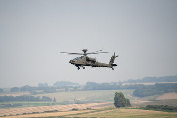 close-up side view of a British army Boeing Apache Attack helicopter gunship AH64E AH-64E ArmyAirCorp in low level flight