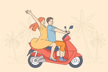 Couple rides scooter along road of tropical resort, enjoying trip to beach with palm trees