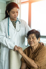 Elderly hospice home care for senior elder patient with Asian aging old adult woman nursing with...