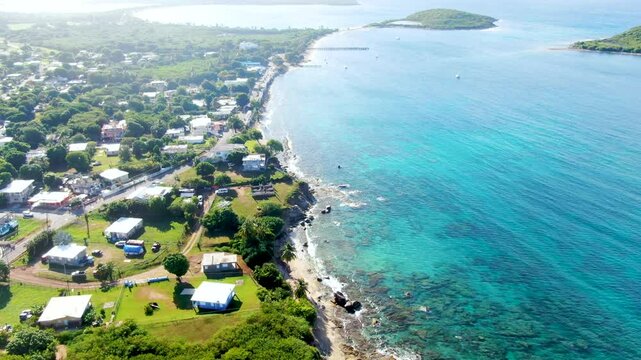 Aerial of the Esperanza neighborhood and tropical ocean with islands Cayo Real and Cayo de Tierra in the distance