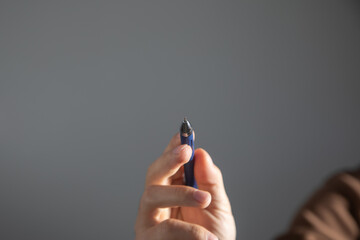 Male hand with a pen writes in empty screen.