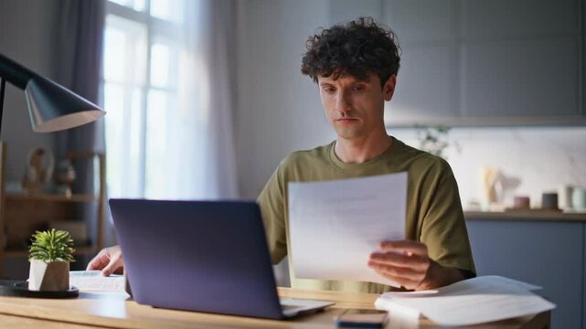 Online worker typing computer analyzing documents at remote workplace closeup