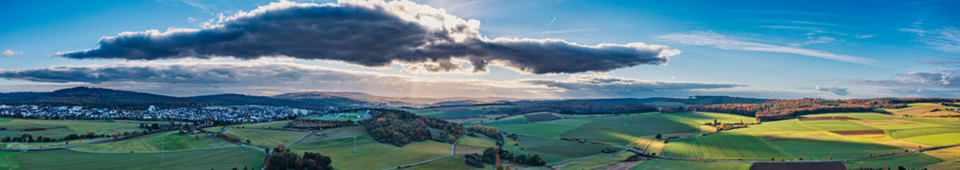 Aerial panorama of the landscape in the Taunus in autumn with a huge dark cloud