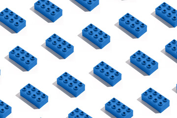 Pattern of many blue plastic building block bricks toy for constructor on white isolated background. The concept of children's educational games. Image for your design