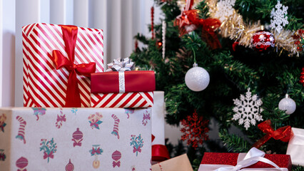 Beautiful gift boxes under a modern Christmas tree in a home, adorned Xmas