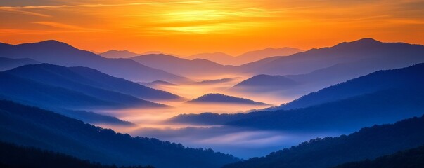 Obraz premium The misty hills and peaks glow in the warm morning light, with colorful skies and fog adding an ethereal touch. Sunrise paints the horizon in shades of orange and yellow, perfect for nature lovers