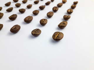 Roasted coffee beans arranged on a white background
