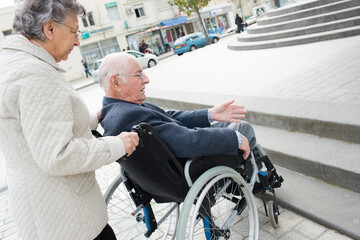 a senior couple in wheelchair