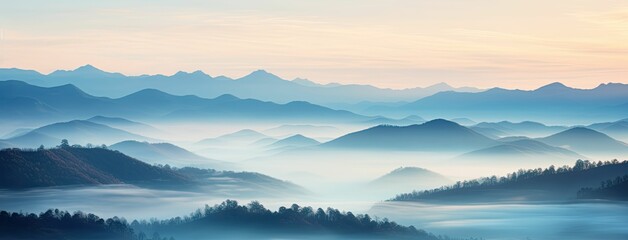 Fototapeta premium Misty mountains at dawn, serene landscape.