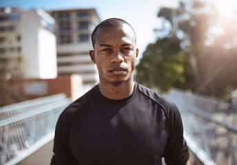 Obraz premium Black man, runner and portrait in city for fitness, health and start workout in morning on bridge. African athlete, person and outdoor in town for training, exercise and ready for challenge in Kenya