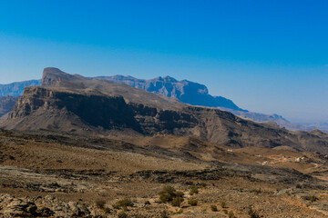 Stunning views of Oman’s rugged mountains showcasing natural beauty under a clear blue sky in the middle of the day