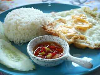Fried egg on rice in a plate, delicious and popular Thai food.