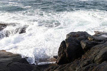 Ocean waves crushing on the rocky Tungeneset beach, Senja, Norway. Seasonal scenery of Scandinavia.