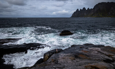 Ocean waves crushing on the rocky Tungeneset beach, Senja, Norway. Seasonal scenery of Scandinavia.