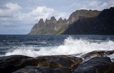 Ocean waves crushing on the rocky Tungeneset beach, Senja, Norway. Seasonal scenery of Scandinavia.