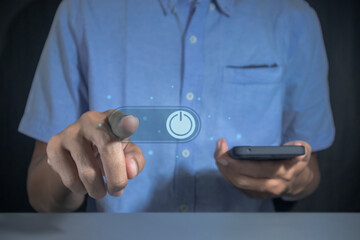 Man pressing power button on virtual screen to turn on or off a smartphone