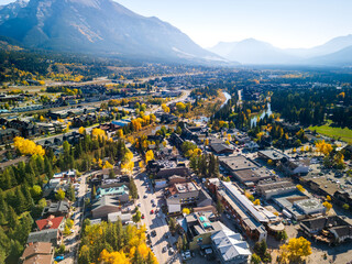 Aerial view of Town of Canmore downtown area in a autumn sunny day. Canadian Rockies mountain range in background. Alberta, Canada.