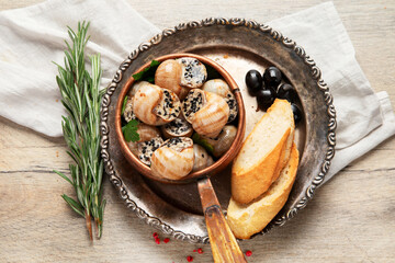 Bourgogne Escargot Snails with garlic oil in a metal plate.