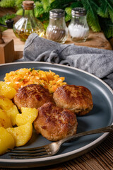 Meatballs  served with fired potatoes.