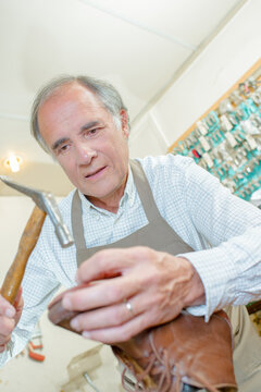 a man is repairing shoe