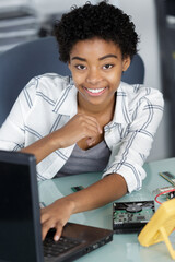 a woman fixing computer indoors