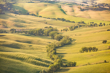 MONTEPULCIANO, ITALY - : Tuscany amazing landscape. Typical view for the region tuscan countryside farm house, green field hills, vineyard, cypresses trees in day sun lights from city walls .