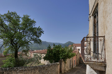 Fototapeta premium A small street among the old houses of a Moliterno, small town in Basilicata, Italy.