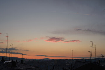 Purple clouds at sunset over the old rooftops