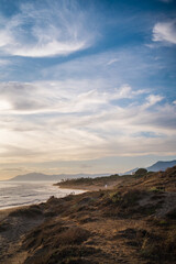  A picturesque wooden boardwalk stretches out towards the calm ocean under a morning sky. The soft early light and tranquil sea make for a serene and inviting scene