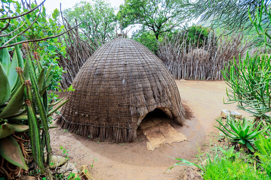 Traditional Swazi homestead featuring unique hut design in a village of Eswatini surrounded by lush greenery