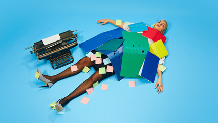 Woman in office attire lying collapsed under piles of colorful folders and sticky notes,...