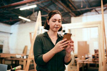Phone, woman and carpenter in workshop for woodwork, creative design or construction project....