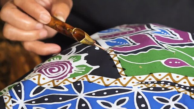 Traditional hand-drawn batik art is done by writing on a piece of white cloth.