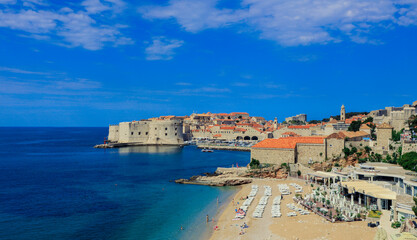 Stunning view of Dubrovnik coastline featuring historic architecture and clear blue skies during a sunny day