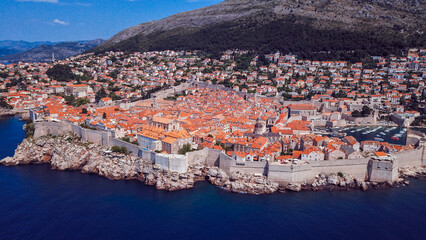 Aerial view of the historic city of Dubrovnik Croatia showcasing its iconic red rooftops and fortified walls along the coastline