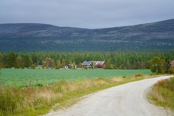 Fototapeta premium Scenic rural landscape with mountains and a dirt road.