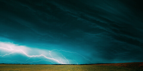 Countryside Rural Wheat Field Meadow Landscape In Summer Rainy Day. Scenic Sky With Rain Clouds On...