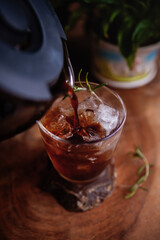 Making refreshing Espresso Tonic, cold-brew tonic on a wooden table